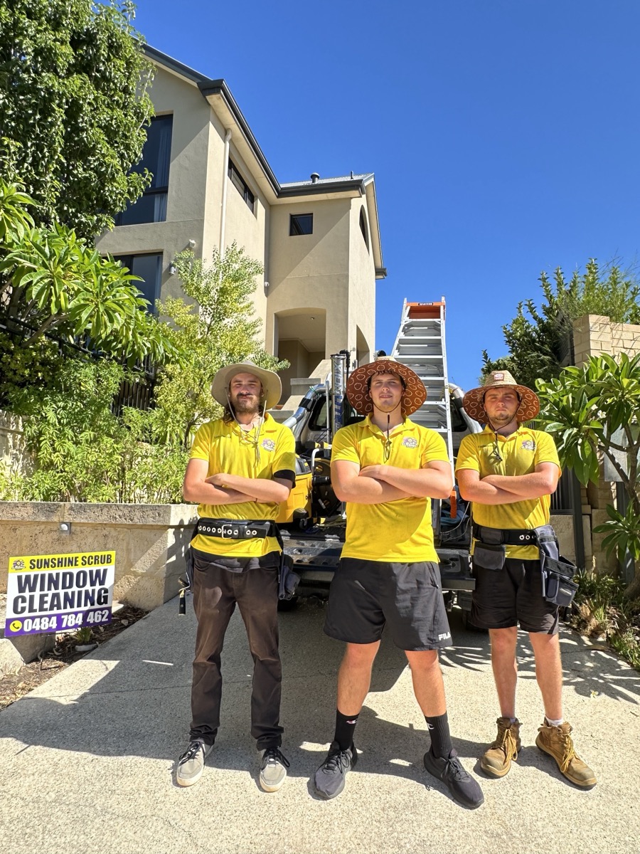 The Sunshine Scrub crew in their yellow uniforms in front of the work truck